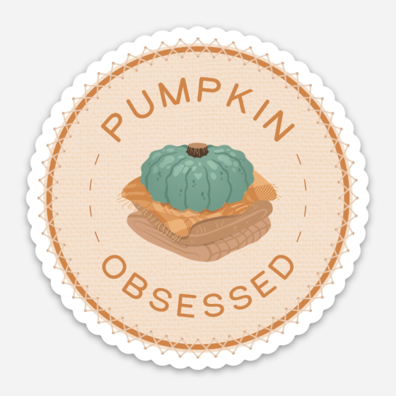 blue pumpkin on a stack of plaid blankets with the words "pumpkin-obsessed" in a cirdle